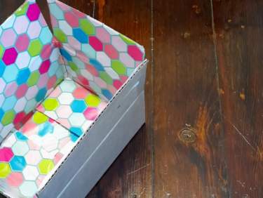 Here's how to easily wrap the inside of a box-- for gift giving or for care packages. This method is cheap, fast, and works on rectangular or square boxes. #carepackage #craft #crafting #wrapping #snailmail #deployment #christmasgifts